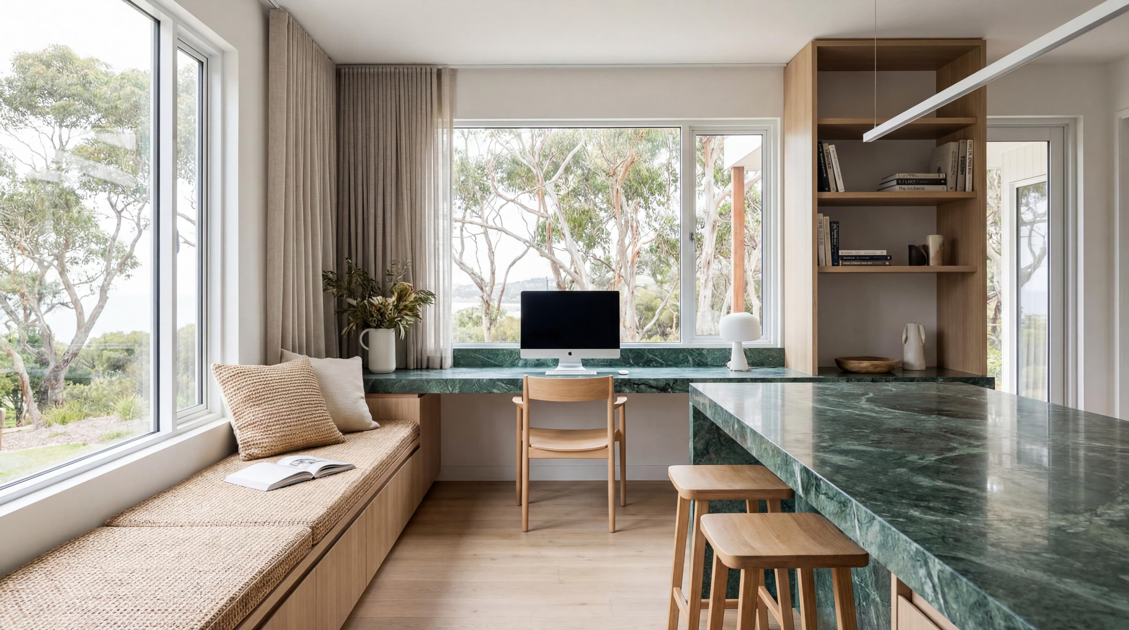 Coastal home office fitout with green marble desk surface, built-in timber joinery, window seat, and natural bush outlook — Hastings